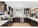 Modern kitchen with stainless steel appliances, dark wood cabinets, white countertops, and tile backsplash at 1531 75Th Ne Cir, St Petersburg, FL 33702