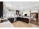 Modern kitchen with white counters, tile floors, and dark wood cabinets creates a clean and functional cooking space at 1531 75Th Ne Cir, St Petersburg, FL 33702