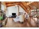 Open-concept living room with wood-beamed ceilings, stone fireplace, and hardwood floors creates a warm and inviting atmosphere at 1531 75Th Ne Cir, St Petersburg, FL 33702