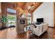 Bright living room featuring vaulted ceilings, stone fireplace, hardwood floors, and waterfront views at 1531 75Th Ne Cir, St Petersburg, FL 33702
