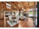 Expansive living room with wood floors, stone fireplace, and a loft above provides an inviting space for relaxation at 1531 75Th Ne Cir, St Petersburg, FL 33702