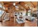 Spacious living room with wood paneled walls, stone fireplace, and staircase leading to a loft at 1531 75Th Ne Cir, St Petersburg, FL 33702