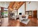 Inviting living room with stone fireplace, hardwood floors, vaulted ceiling, and natural light at 1531 75Th Ne Cir, St Petersburg, FL 33702
