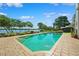 Beautiful waterfront pool with brick trim and lush landscaping under a sunny sky at 1531 75Th Ne Cir, St Petersburg, FL 33702
