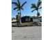 Charming single-story home with front lawn, mature landscaping, and carport at 15416 2Nd E St, Madeira Beach, FL 33708