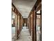Hallway with exposed studs, featuring lighting, access to other rooms, and a peek at the toilet at 15416 2Nd E St, Madeira Beach, FL 33708
