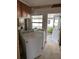 Utility room featuring a washing machine and dryer along with a bright, airy window at 15416 2Nd E St, Madeira Beach, FL 33708