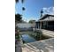 Backyard pool surrounded by brick pavers, overlooked by the rear of the home at 15416 2Nd E St, Madeira Beach, FL 33708