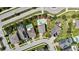 Aerial shot of the property showcasing the pool, landscaping, and proximity to nearby roads and neighborhood at 1669 Feather Grass Loop, Lutz, FL 33558