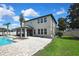 Spacious backyard featuring a pool, patio, and green lawn, offering a great outdoor living space at 1669 Feather Grass Loop, Lutz, FL 33558