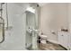 Modern bathroom featuring a glass-enclosed shower, pedestal sink, and stylish wood-look tile flooring at 1669 Feather Grass Loop, Lutz, FL 33558