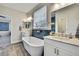 Beautiful bathroom showcasing double vanities, soaking tub, and chic lighting, offering a spa-like experience at 1669 Feather Grass Loop, Lutz, FL 33558