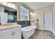 Luxurious bathroom featuring double sinks, stylish modern tub, and elegant fixtures creating a spa-like oasis at 1669 Feather Grass Loop, Lutz, FL 33558