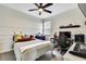 Bright bedroom with plush decorations, a ceiling fan, and a dedicated workspace at 1669 Feather Grass Loop, Lutz, FL 33558