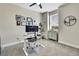 Modern bedroom with a functional desk area, neutral tones, and plenty of natural light at 1669 Feather Grass Loop, Lutz, FL 33558