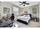 Comfortable bedroom with a dedicated workspace, natural light, and tasteful decor at 1669 Feather Grass Loop, Lutz, FL 33558
