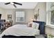 Comfortable bedroom with a dedicated workspace, natural light, and tasteful decor at 1669 Feather Grass Loop, Lutz, FL 33558