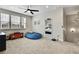 Cozy bonus room with plush carpeting, ceiling fan, and convenient access to another bedroom creating a flexible space at 1669 Feather Grass Loop, Lutz, FL 33558