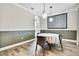 Elegant dining room featuring stylish lighting, wood-look tile flooring, and wainscoting at 1669 Feather Grass Loop, Lutz, FL 33558