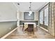 Charming dining area with designer lighting, wood-look flooring, and large windows providing natural light at 1669 Feather Grass Loop, Lutz, FL 33558