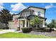 Beautiful two-story home with a manicured lawn, professional landscaping, and an attached two-car garage at 1669 Feather Grass Loop, Lutz, FL 33558