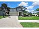 Charming two-story home with a well-manicured lawn, a paved driveway, and a basketball hoop at 1669 Feather Grass Loop, Lutz, FL 33558