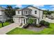 Charming two-story home with a well-manicured lawn and a welcoming front porch. Garage and driveway included at 1669 Feather Grass Loop, Lutz, FL 33558
