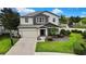 Inviting two-story home with a well-manicured lawn and brick driveway, featuring an attached two-car garage at 1669 Feather Grass Loop, Lutz, FL 33558