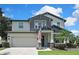 Beautiful two-story home with attached garage, complemented by a well-kept lawn and appealing landscaping at 1669 Feather Grass Loop, Lutz, FL 33558