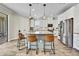 Bright kitchen featuring a granite island with bar seating and stainless steel appliances at 1669 Feather Grass Loop, Lutz, FL 33558