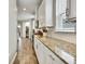 Modern kitchen with granite counters, white cabinets, and tile backsplash at 1669 Feather Grass Loop, Lutz, FL 33558