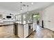Open kitchen island with seating that looks out to the living room and outdoor dining space at 1669 Feather Grass Loop, Lutz, FL 33558
