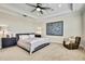Spacious primary bedroom showcasing neutral tones, ceiling fan, and walk-in closet for a comfortable and organized space at 1669 Feather Grass Loop, Lutz, FL 33558