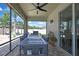 Covered patio featuring a ceiling fan and an outdoor dining area with a grill, perfect for entertaining at 1669 Feather Grass Loop, Lutz, FL 33558