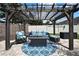 Outdoor seating area with a pergola, cozy seating, and decorative rug, perfect for relaxing at 1669 Feather Grass Loop, Lutz, FL 33558