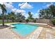 Backyard pool with stone surround, water feature, and a spacious patio perfect for outdoor relaxation at 1669 Feather Grass Loop, Lutz, FL 33558