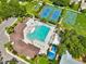 Aerial view of community pool, tennis courts, basketball court, and playground at 1706 Erin Brooke Dr, Valrico, FL 33594