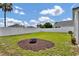 Spacious backyard with lush lawn and a fire pit at 1706 Erin Brooke Dr, Valrico, FL 33594