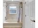 Bathroom with bathtub and shower featuring neutral tile at 1706 Erin Brooke Dr, Valrico, FL 33594
