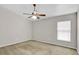Neutral bedroom featuring a ceiling fan, light walls, and bright window at 1706 Erin Brooke Dr, Valrico, FL 33594