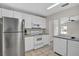 Well-lit kitchen featuring stainless steel appliances and white cabinetry at 1706 Erin Brooke Dr, Valrico, FL 33594