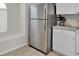 Updated kitchen with stainless steel fridge and white cabinets at 1706 Erin Brooke Dr, Valrico, FL 33594