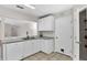 Well-lit kitchen featuring white cabinets, neutral countertops and tile floors at 1706 Erin Brooke Dr, Valrico, FL 33594