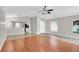 Bright living room with wood floors, ceiling fan and an open floor plan at 1706 Erin Brooke Dr, Valrico, FL 33594