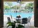 Relaxing view of the community pool with poolside seating under palm trees at 1706 Erin Brooke Dr, Valrico, FL 33594