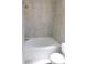 Well-lit bathroom featuring a white tiled shower and tub, along with a modern shower head at 2114 Intervista Ln, Valrico, FL 33594