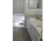 Bright bathroom featuring a double sink with granite countertops and a tiled shower and tub combo at 2114 Intervista Ln, Valrico, FL 33594