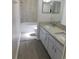 Bright bathroom featuring a double sink with granite countertops and a tiled shower and tub combo at 2114 Intervista Ln, Valrico, FL 33594