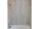 Well-lit bathroom featuring a white tiled shower and tub, along with a modern shower head at 2114 Intervista Ln, Valrico, FL 33594