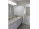 Bathroom featuring a double sink with granite countertops and a view into the bedroom at 2114 Intervista Ln, Valrico, FL 33594